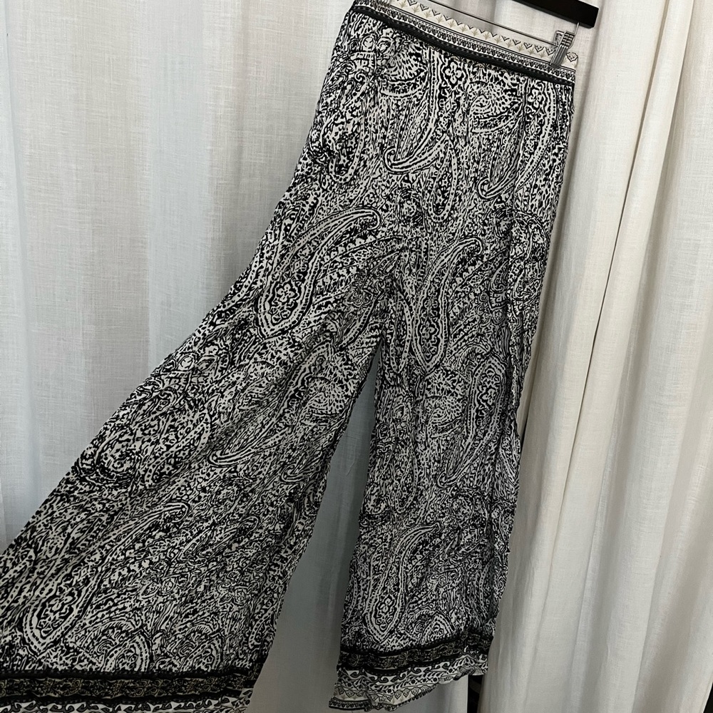 Flowy paisley pants with leg slits.